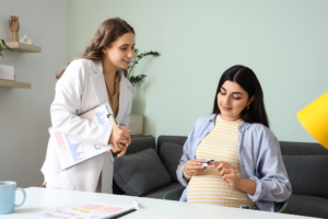 Pregnant woman checking blood sugar level with glucometer while consulting a doctor